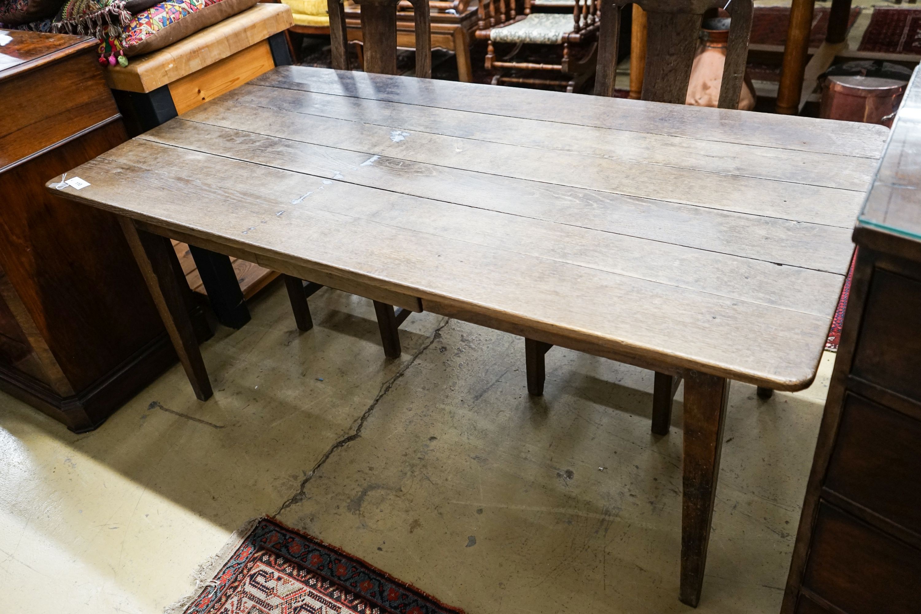 An early 19th century French provincial oak farmhouse table, fitted drawer, length 175cm, depth 86cm, height 73cm